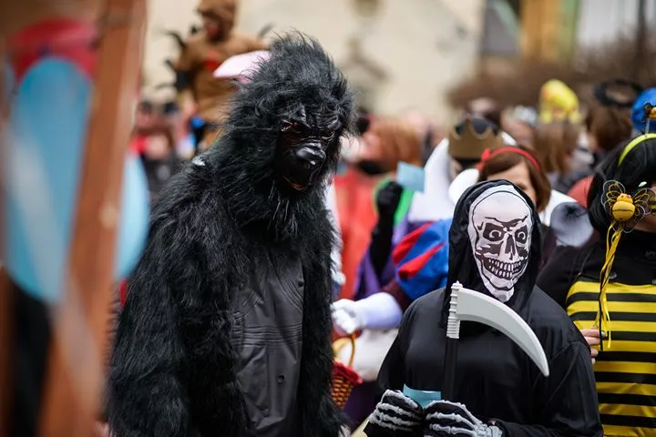 People in Halloween costumes celebrating in a street parade