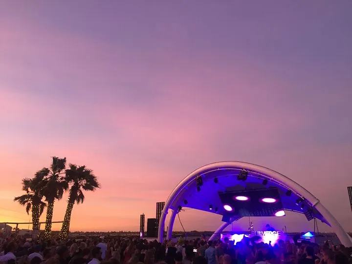 An outdoor festival stage at sunset